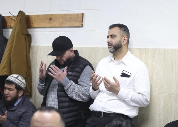 Amer Alrifaee, right, prays during a vigil for Mohammed al Hijoj at the Islamic Community Center of Illinois in Belmont Cragin on Dec. 5, 2023. 